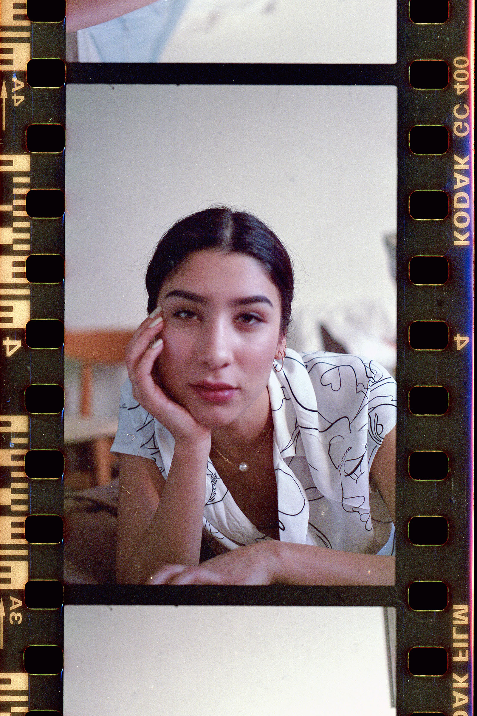 Nadya Inzunza Film Photo a series of three photographs showcasing a person in various poses with a film reel border indicating the medium of the photographs.